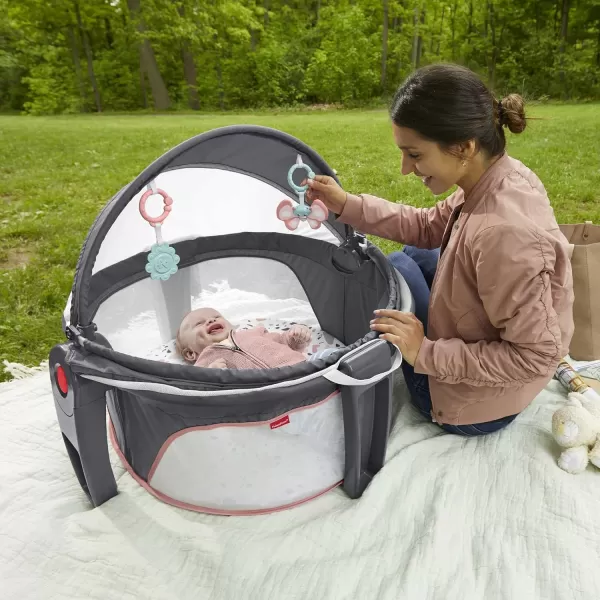 FisherPrice Portable Bassinet OnTheGo Baby Dome Travel Play Space with Developmental Newborn Toys ampamp Canopy Pink Pacific Pebble